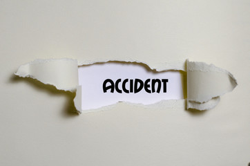 The word accident appearing behind torn paper - 124487464