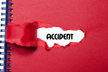 The word accident appearing behind torn paper