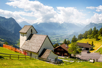 Beautiful rural scene in Triesenberg village with mountains in Liechtenstein - obrazy, fototapety, plakaty