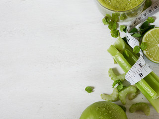Vegetable juice, apple, sliced lime on the white wooden background. Template for detox recipe. Mock-up.