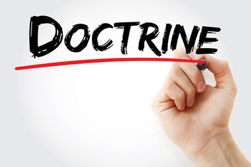 Hand writing Doctrine with marker, concept background