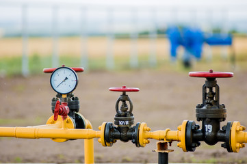 Red faucets with steel pipe in natural gas treatment plant