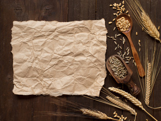Wheat and spelt on wooden background