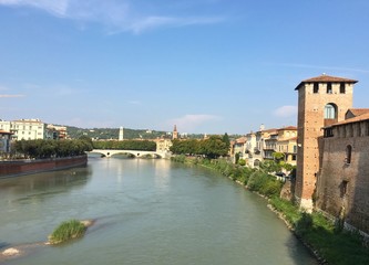 Fototapeta na wymiar VERONA, ITALY - SEPTEMBER 3, 2016 : cityscape of the old town of Verona and its river during summer.