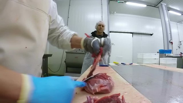 Hands Of Butcher Cutting Slices Of Fresh Meat 