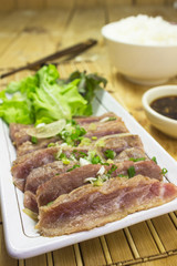 Place the sliced beef on white plate with salad place.