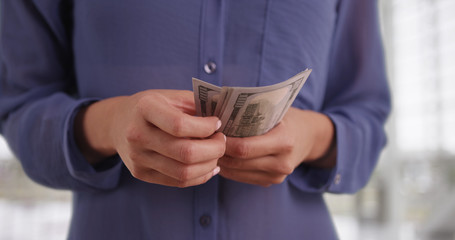 Mexican woman counting her cash withdrawal