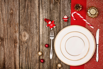 Christmas decoration background over wooden table with red cloth.
