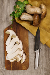 top view of three boletus  with parsley and knife