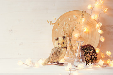 Christmas home decoration with lights on  white wooden background. Interior.