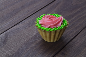 Shortbread cake with cream on a dark wooden background