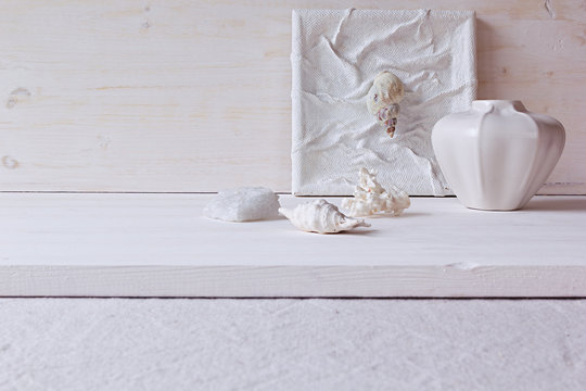 Soft home decor;  shells and corals on white wooden background. Interior.