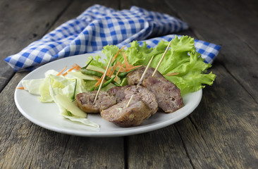 Sour pork and vegetable snacks in Thailand On the wooden floor