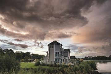 Beautiful dramatic clouds formation over lake landscape immediat