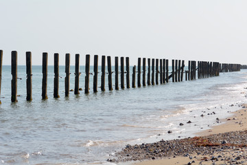 Wooden sea defences damaged in 2015 storms in Sheringham, Norfolk, England
