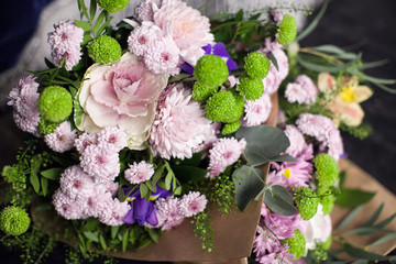 bouquet of flowers in kraftovy paper. pink and green flowers in 