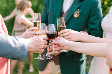 glasses in hands of guests at a wedding party. wedding party. gl