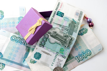 Thousandths bills and an open gift box with a bow  