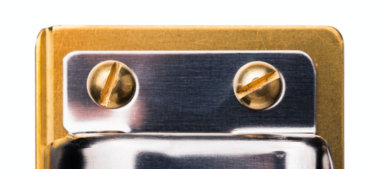 Close up shot of two gold screw heads. Topside view