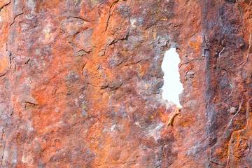 Rusty eroded metal sea defences on coast