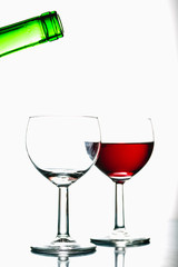 Pouring wine into the glasses, white background, isolated