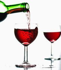 Pouring wine into the glasses, white background, isolated