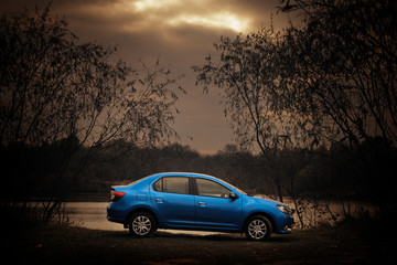 Fototapeta na wymiar blue car on a dark background