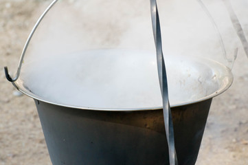 Water boiling the cauldron and produces steam