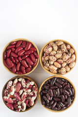 Four kinds of beans on white background. Top view.