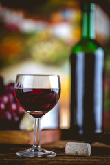 Glass of wine on wooden table, atmospheric composition