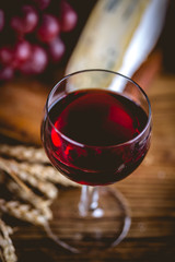Glass of wine on wooden table, atmospheric composition