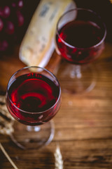 Glass of wine on wooden table, atmospheric composition