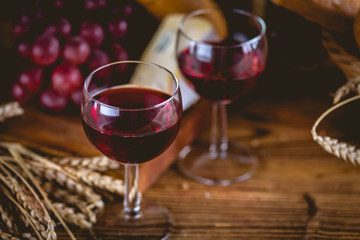 Glass of wine on wooden table, atmospheric composition