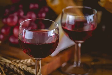 Fotobehang Glass of red wine on wooden table © oleksajewicz