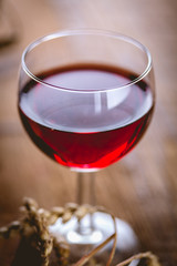 Glass of red wine on wooden table