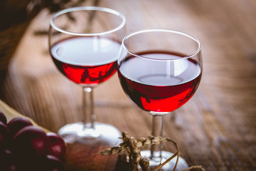 Glass of red wine on wooden table