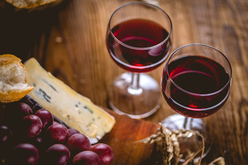 Glass of red wine on wooden table