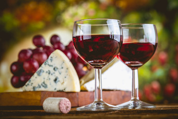 Glass of red wine on wooden table