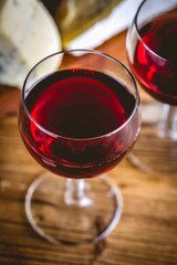 Glass of red wine on wooden table