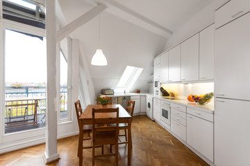 white kitchen with wooden floor in beautiful home -