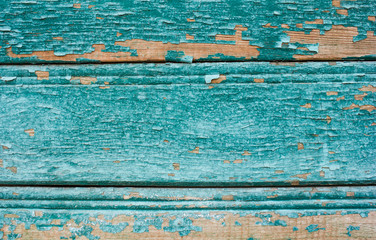 blue coloured cracked paint peeling on wood texture.