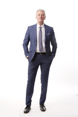 Old businessman portrait.Full length shot of a senior manager standing in suit at isolated white background.