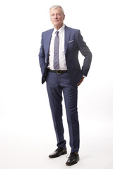Old businessman portrait.Full length shot of a senior manager standing in suit at isolated white background.