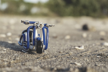 close up image of handcrafted scooter made from wire over blurre