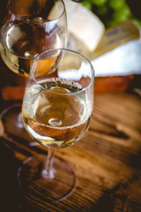 Man is pouring white wine into the glasses