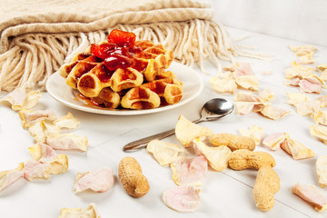 Homemade waffles with orange jam and milk.