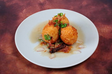 Fried hard-boiled eggs with tamarind sauce call as Khai Luk Keoi in Thai ,which mean egg gift  from son-in-law , is tasty as sweet sour and little spicy topped crispy skin of boiled egg. 
