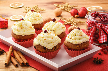 Chocolate cupcakes with cranberries on christmas festive table.