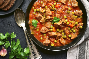 Veal stewed with vegetables in tomato sauce.Top view.