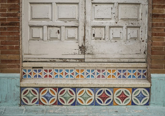 wooden door and steps with colorful tiles